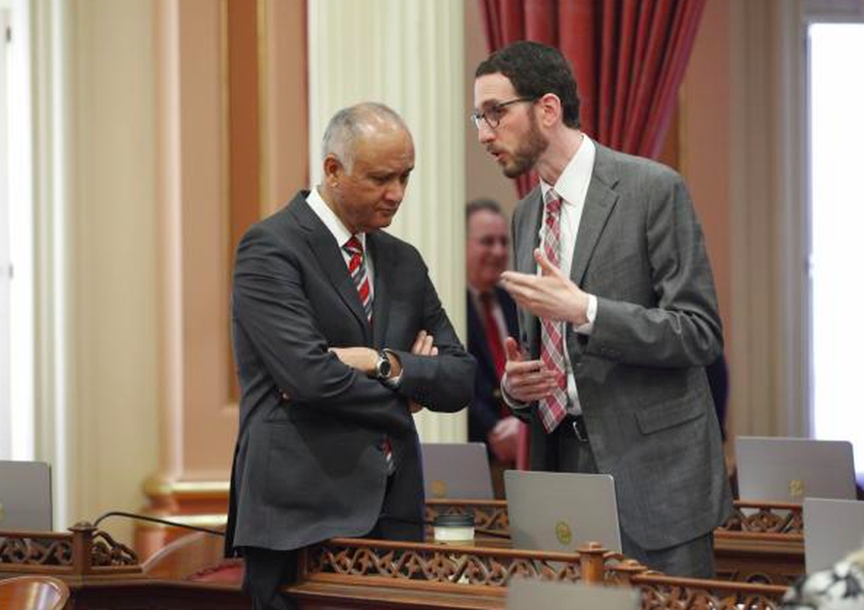 California State Sen. Scott Wiener (right) talks to Sen. Ed Hernandez.